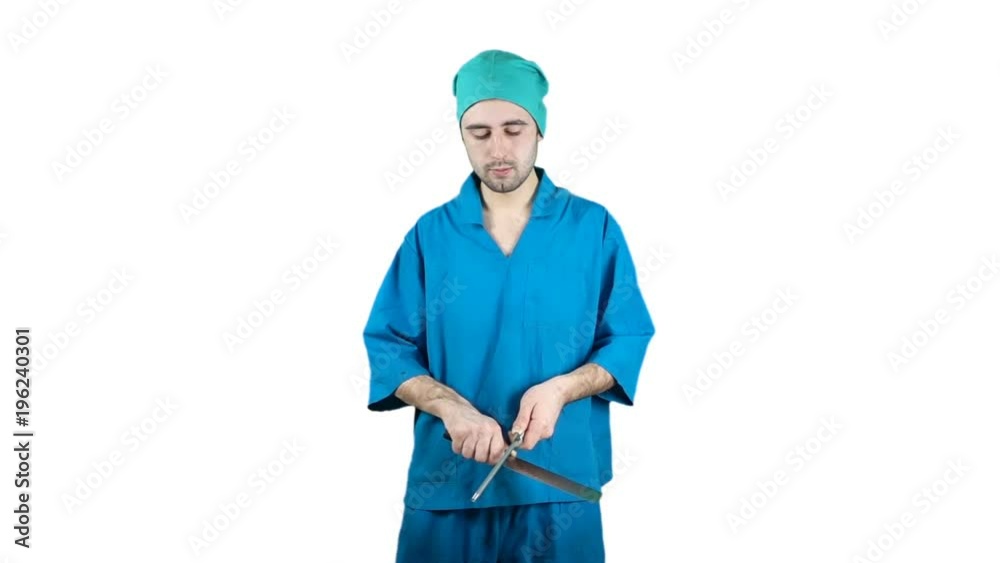 A man in the working clothes of a butcher sharpens a knife in slow motion A man in the working clothes of a butcher sharpens a knife in slow motion