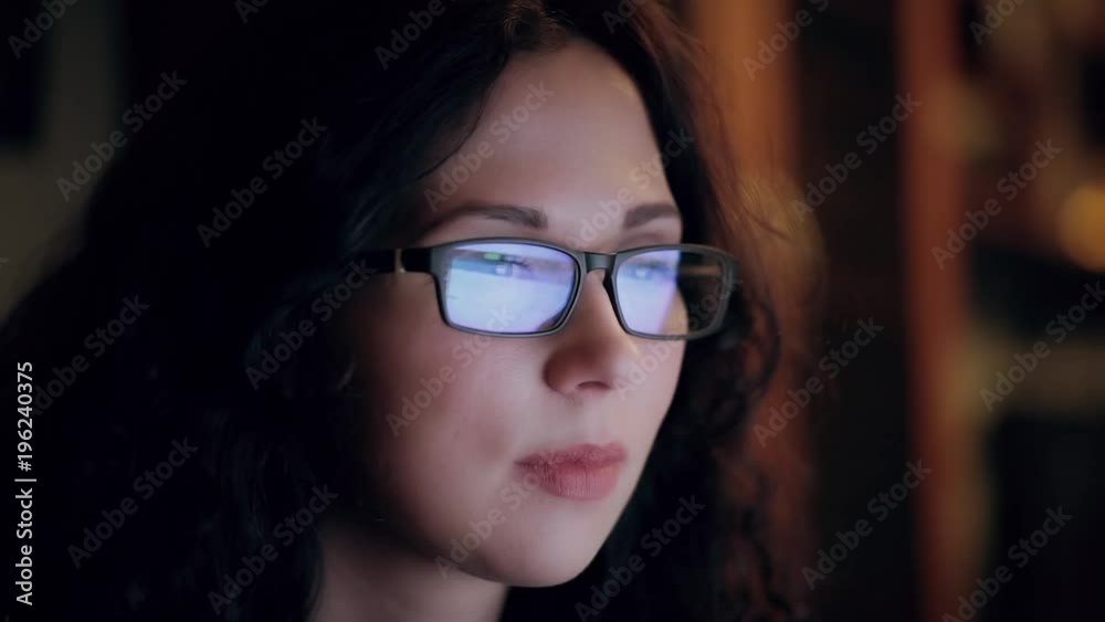 woman with glasses eyes looking at the monitor woman with glasses eyes looking at the monitor