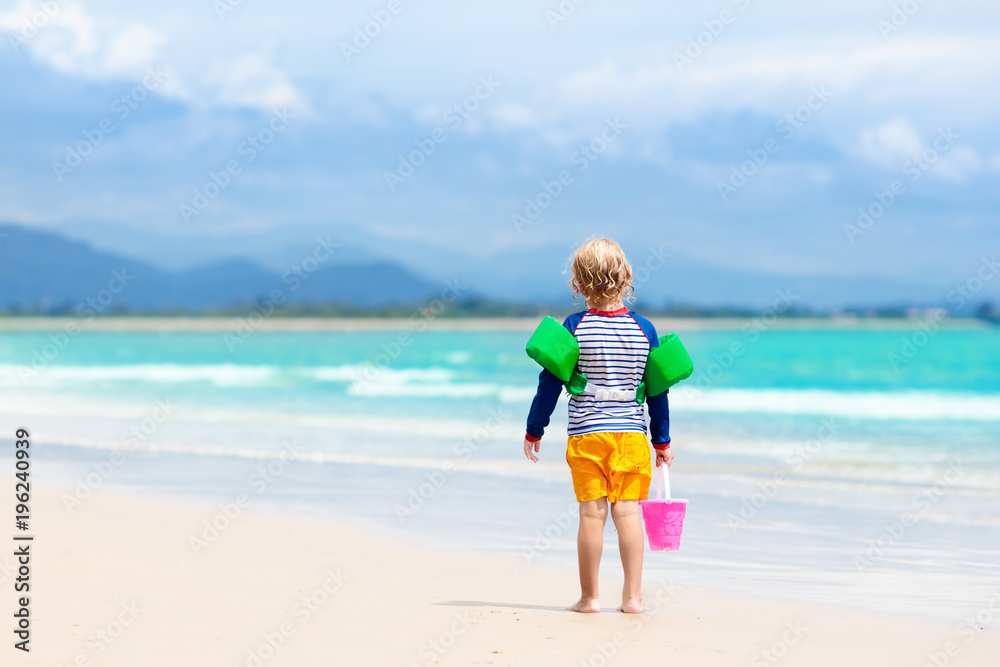 Kids play on tropical beach. Sand and water toy. Kids play on tropical beach. Sand and water toy.