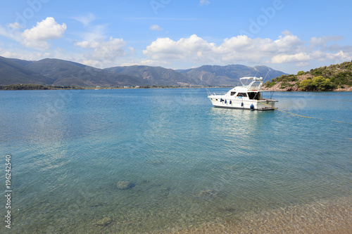 Fototapeta Naklejka Na Ścianę i Meble -  Summer time a beautiful yacht anchoring in Love bay Poros island Greece.