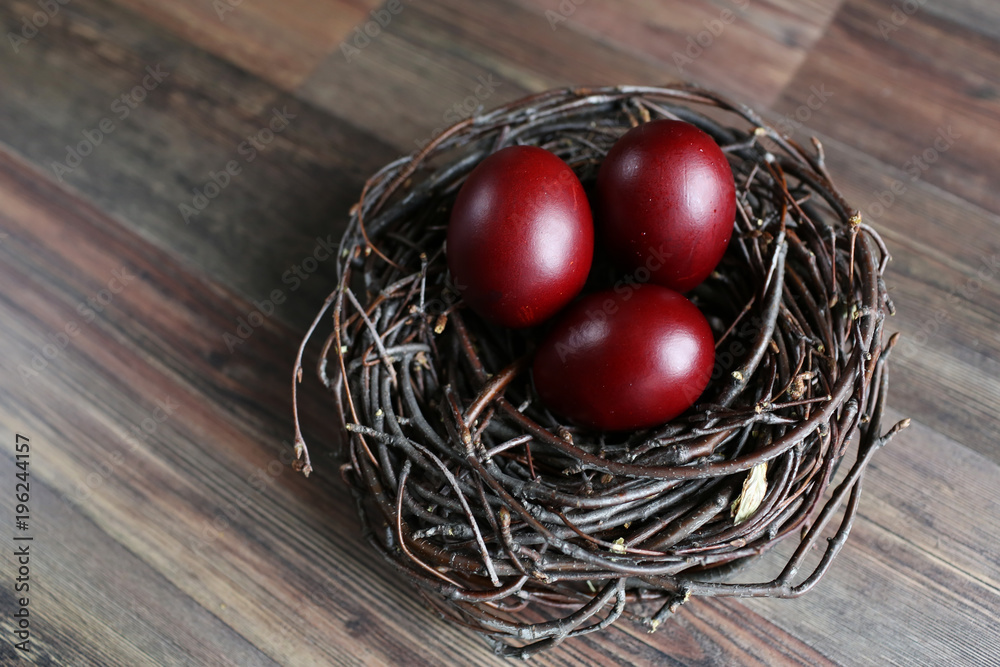 Easter eggs in the nest on wooden background Easter eggs in the nest on wooden background
