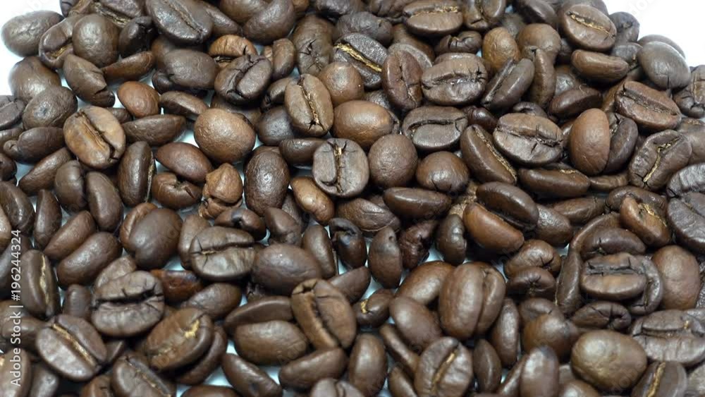 Coffee beans background. Close-up of rotating roasted coffee beans. HD video Coffee beans background. Close-up of rotating roasted coffee beans. HD video