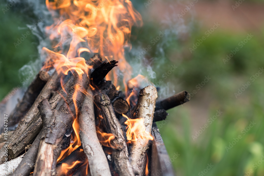 Fototapeta premium Fire burns on the grill, preparation for frying meat