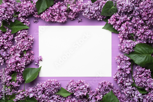 Frame of lilac flowers and blank sheet for notes