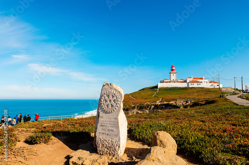 Scenic landscape with Rotary Club monument and lighthouse at the Cabo da Roca, Portugal. photo