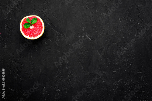 Natural citrus cosmetics. Spa salt near grapefruit on black background top view mockup
