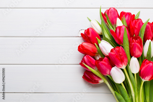 Springt time. Red tulip bouquet on the white wooden background.