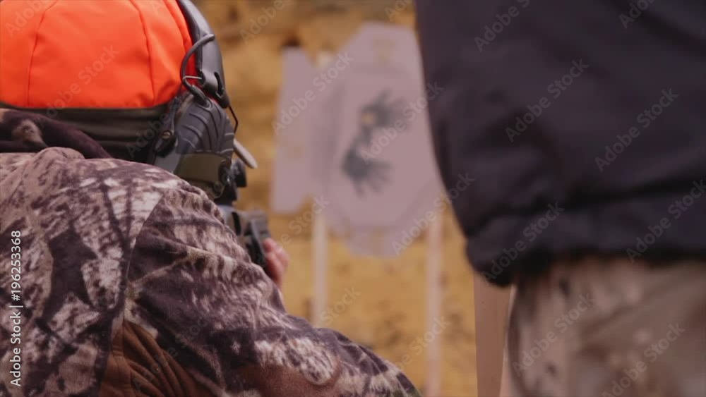 Male training with shotgun  outdoors in field. Hunter with rifle, 