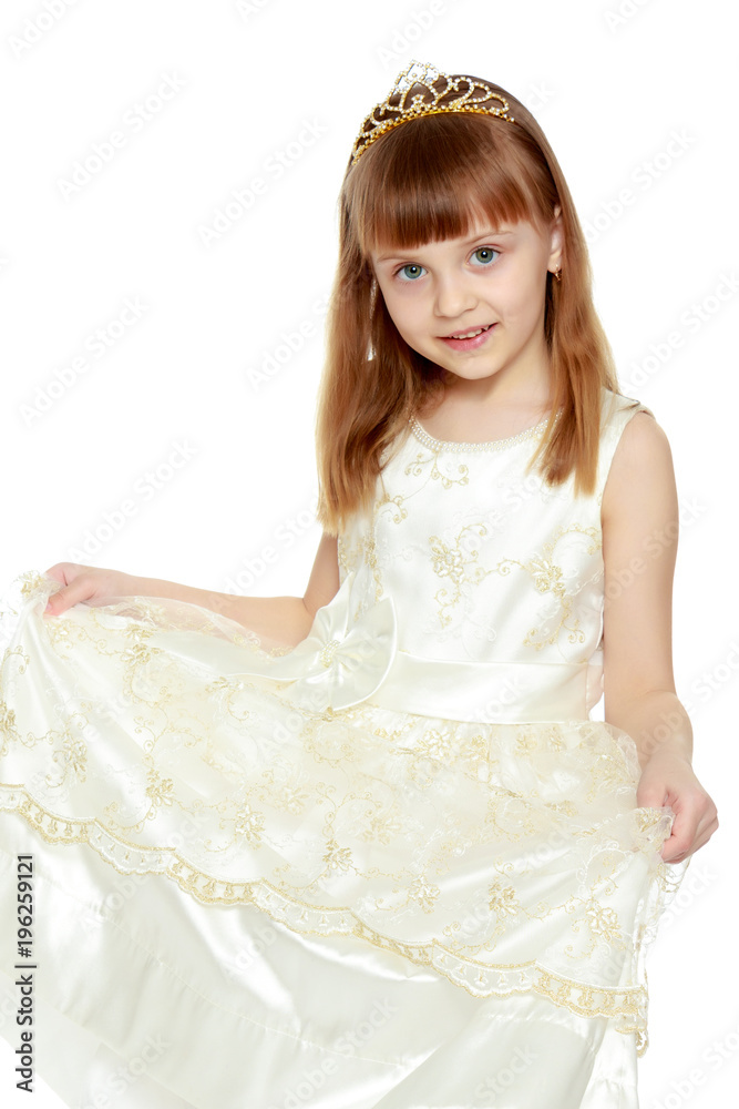 The girl is holding the edges of the dress with her hands. The girl is holding the edges of the dress with her hands.