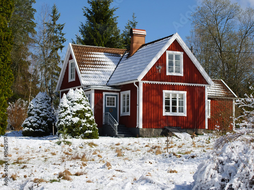 Fotografija Snow covered red cabin in the swedish woods