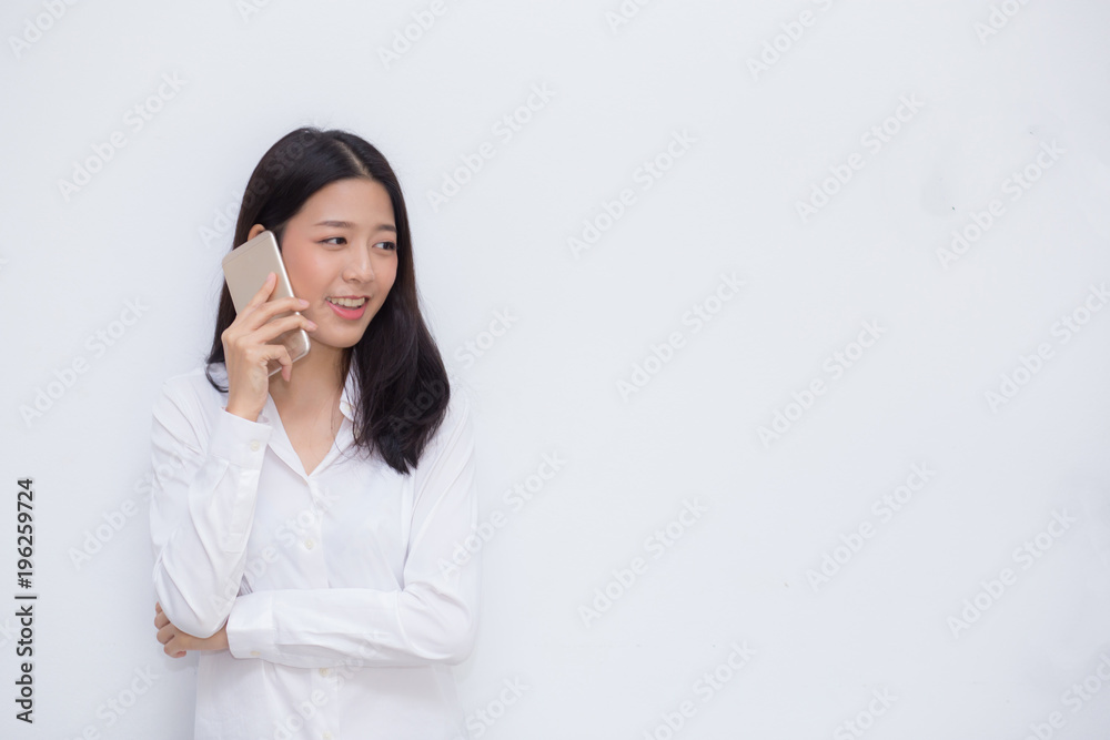 Beautiful young asian woman talking mobile phone and smile standing on cement background, freelancer female calling telephone, communication concept. Beautiful young asian woman talking mobile phone and smile standing on cement background, freelancer female calling telephone, communication concept.