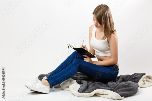 beautiful girl with a notebook and pen in hands
