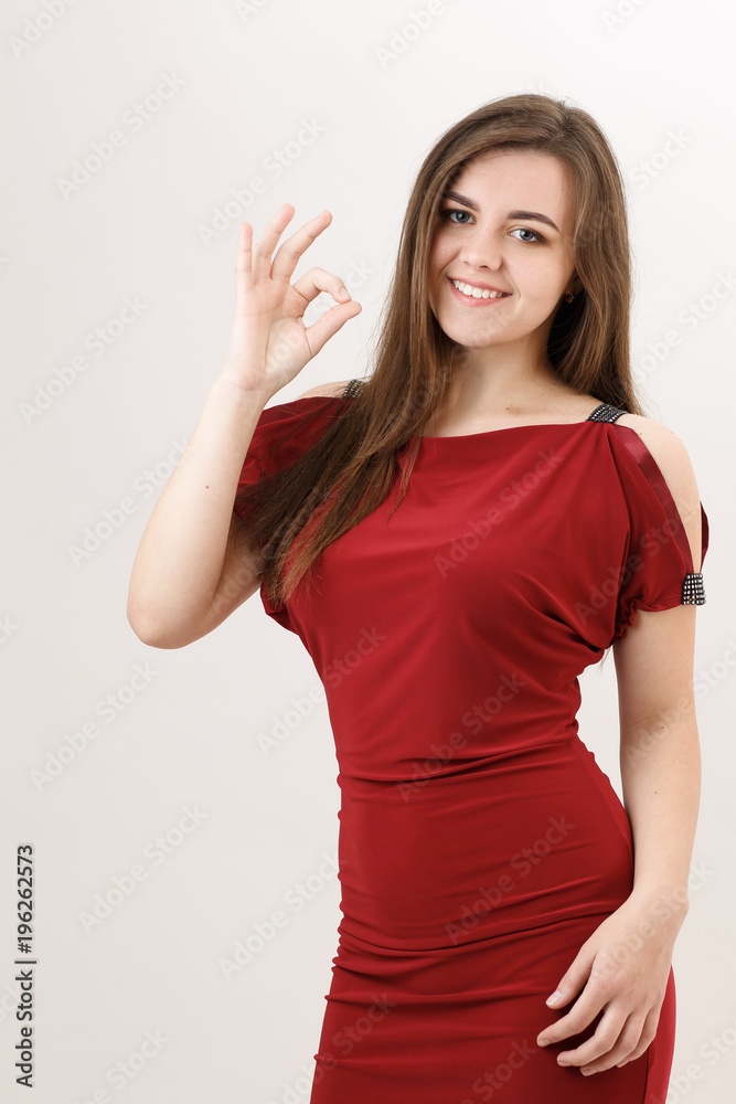 A girl in red shows her fingers okay A girl in red shows her fingers okay