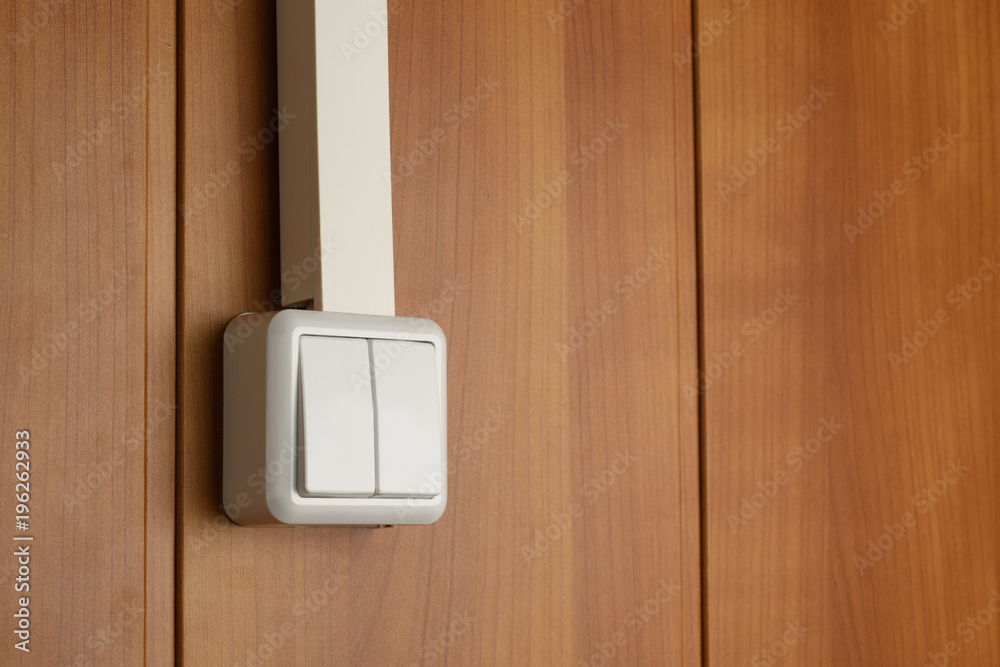 two-column wall switch attached to wooden wall and with cable-channel  hidden power cable Stock Photo