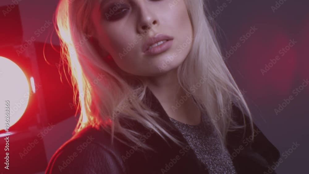 beautiful blonde girl with black glasses posing in studio with red light beautiful blonde girl with black glasses posing in studio with red light