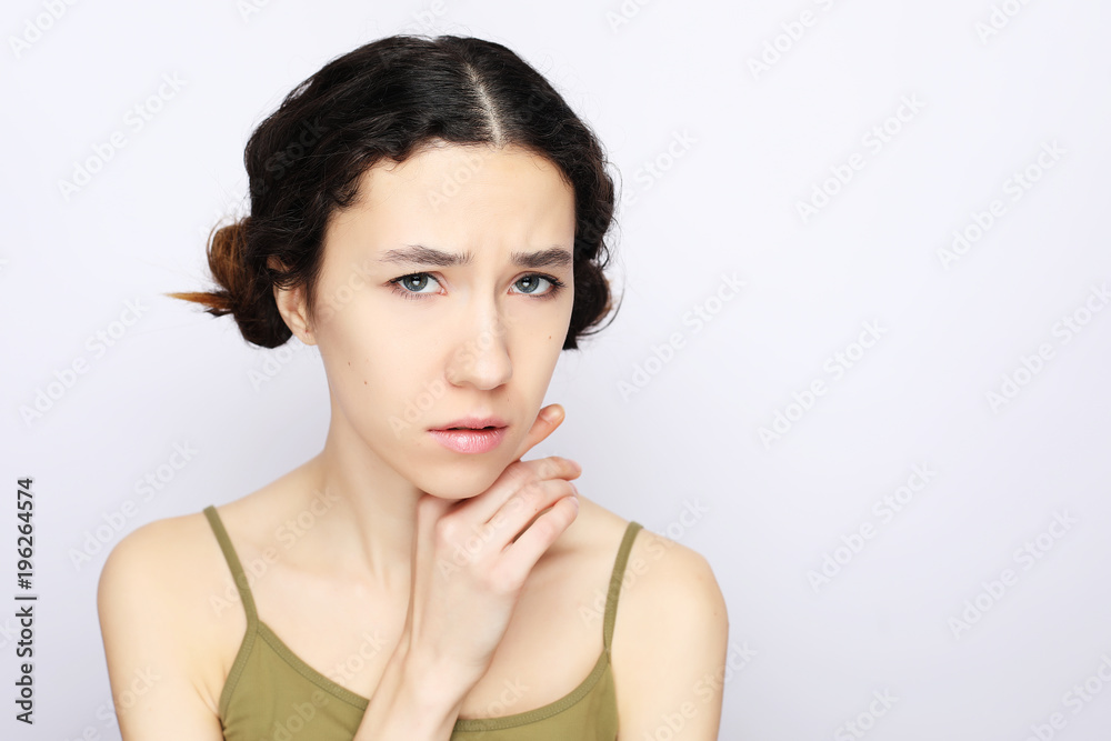 Young cheerful girl looking at camera over white background. Young cheerful girl looking at camera over white background.