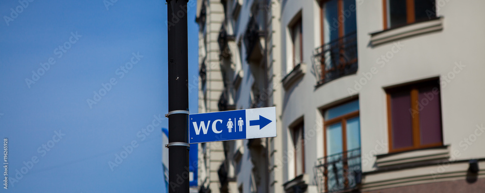 Obraz premium WC sign in old town. Toilet sign in European city