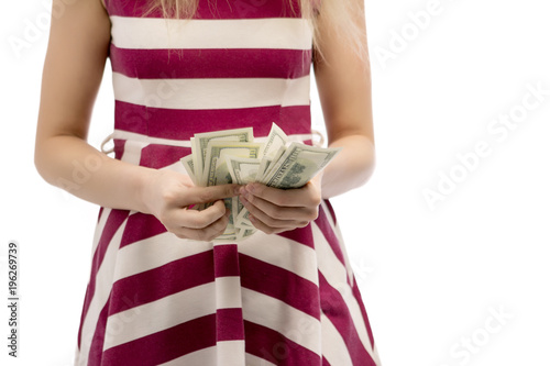Closeup portrait of beautiful asian woman holding money isolated on white background. Asian girl counting her salary dollar note. Success wealth financial business cashflow currency payment concept.
