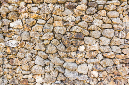 Background wall made of stone.pattern gray color of modern style design decorative uneven cracked real stone wall surface with cement