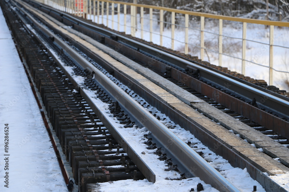 railway in winter. Rails and sleepers - a road for locomotives and electric locomotive covered with snow.