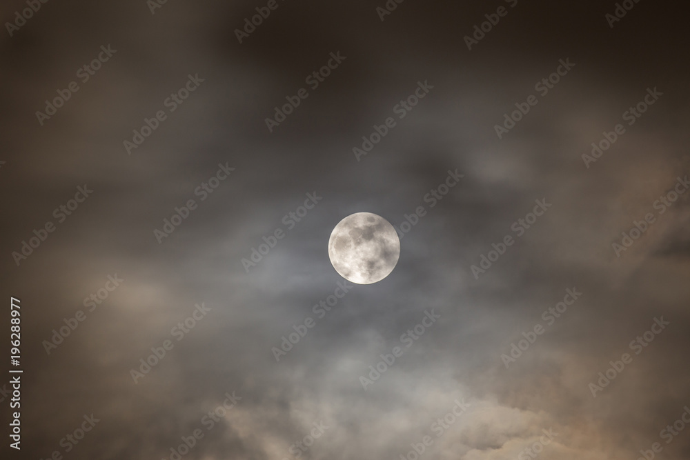 Cloudy full moon night.