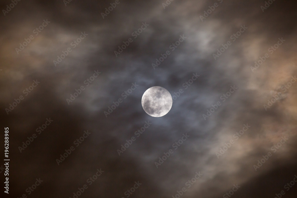 Cloudy full moon night.