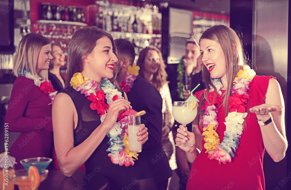 Two women on Hawaiian party at nightclub