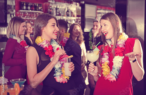 Two women on Hawaiian party at nightclub