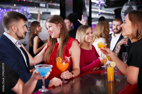 Girl flirting with man on party in bar