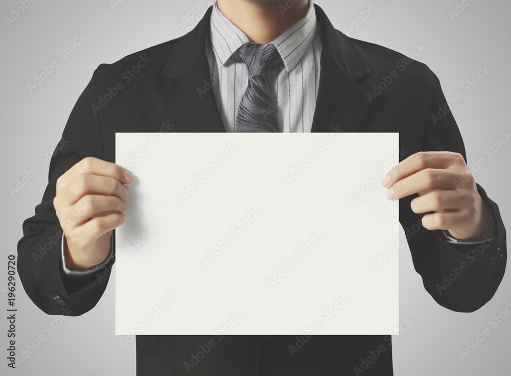 Hand holding white blank paper sheet Hand holding white blank paper sheet