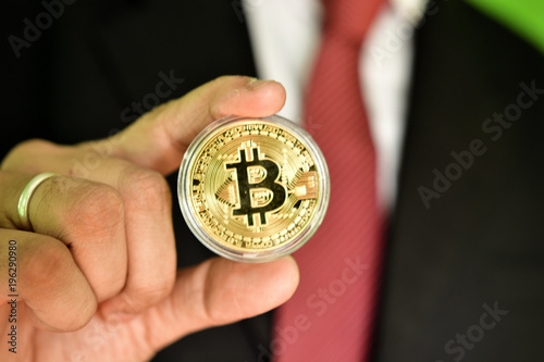 Unrecognizable person holding golden color bitcoin