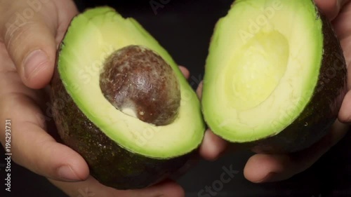 Avocado open by hands