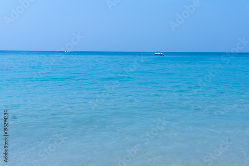 White sand beach and blue sky. Soft wave of blue ocean on sandy beach. Background. concept for summer season.