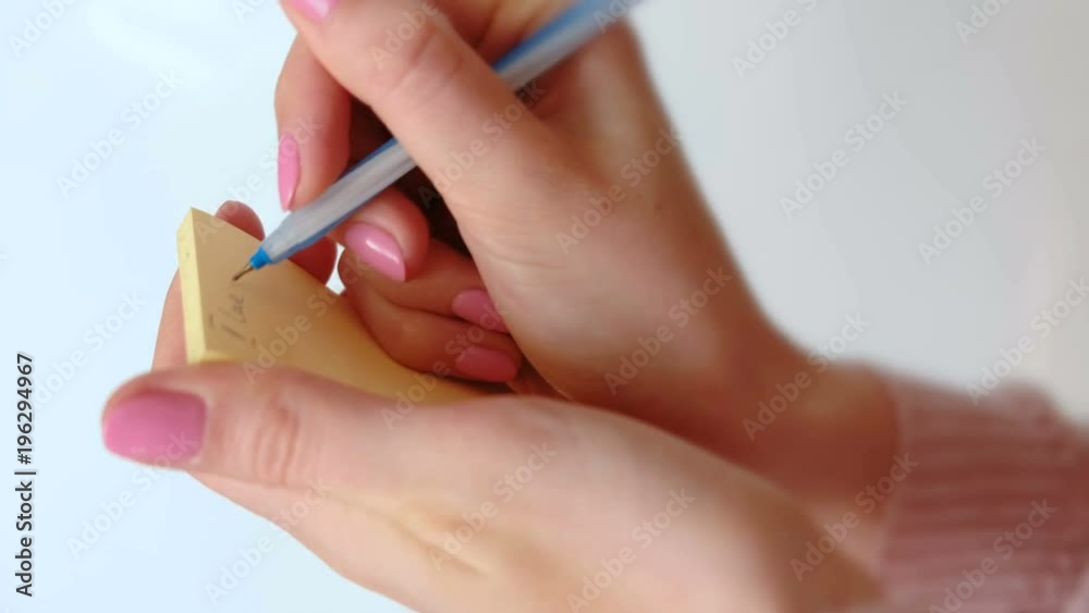 Close up woman's hands writing note 