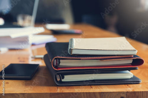 Business and finance concept of office working,Closeup stack of notebook on office desk