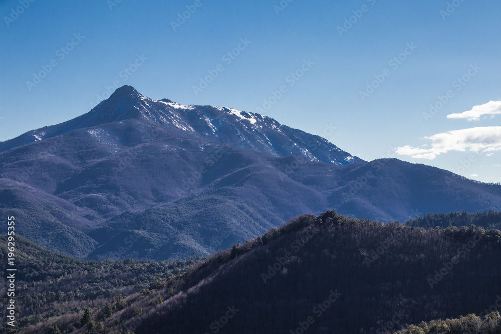 Rocky mountain peak on a blue sunny sky