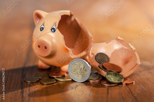 Broken piggy bank and euro coins