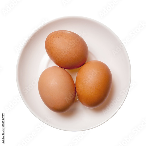 Three brown eggs on plate