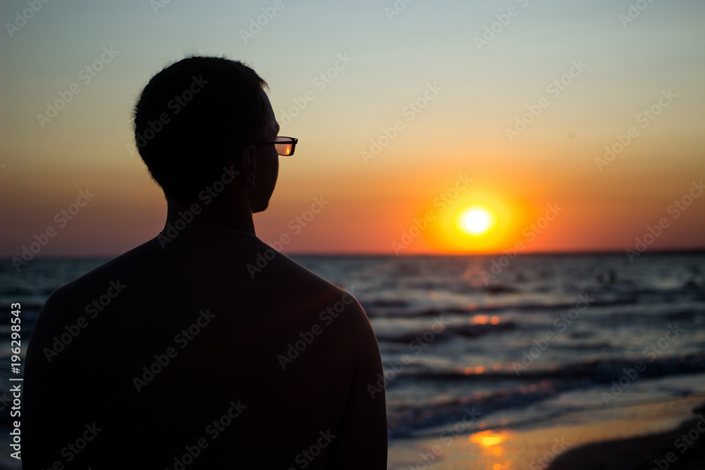 silhouette of a person at sunset in the ocean silhouette of a person at sunset in the ocean