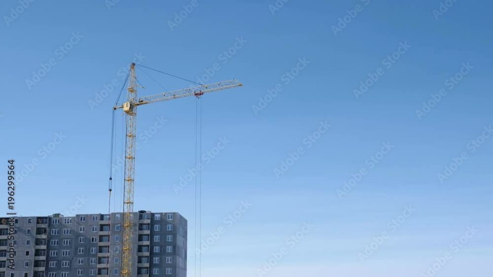 Construction of a multi-storey building. Crane turns to the side. Construction of a multi-storey building. Crane turns to the side.