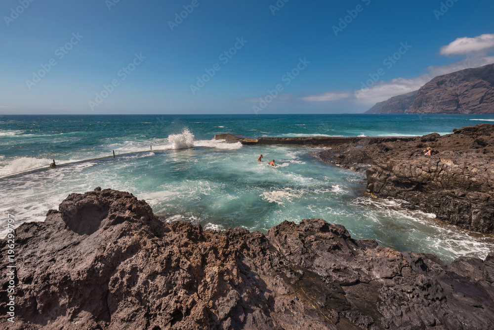 Unidentifiable Tourist swimming in coastline landscape in Puerto Santiago, Tenerife, Spain. Unidentifiable Tourist swimming in coastline landscape in Puerto Santiago, Tenerife, Spain.