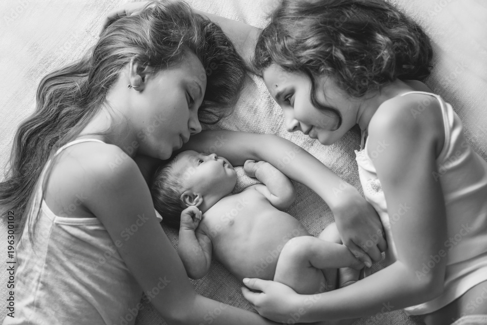 Older sister holding a newborn baby. Older sister holding a newborn baby.