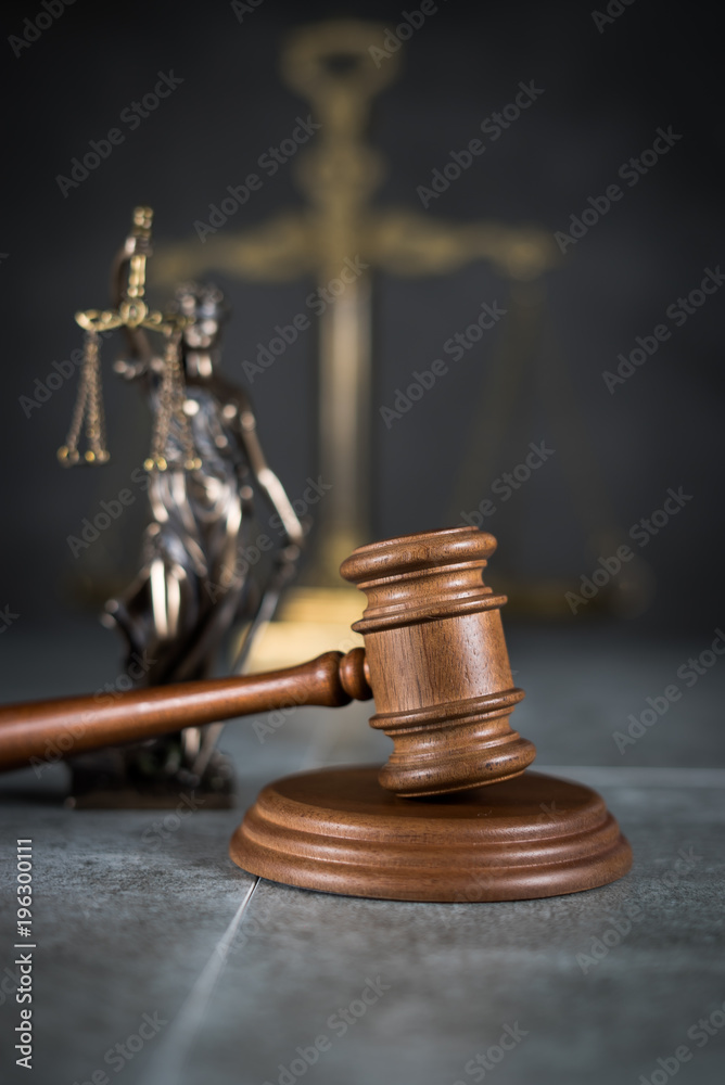 Law and Justice concept. Mallet of the judge, books, scales of justice. Gray stone background, reflections on the floor, place for typography. Courtroom theme. Law and Justice concept. Mallet of the judge, books, scales of justice. Gray stone background, reflections on the floor, place for typography. Courtroom theme.