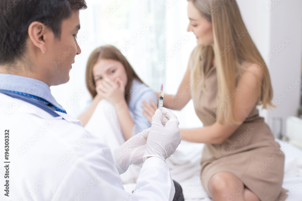 Girl scary to injection from doctor at hospital. People with medical and health care concept. Girl scary to injection from doctor at hospital. People with medical and health care concept.