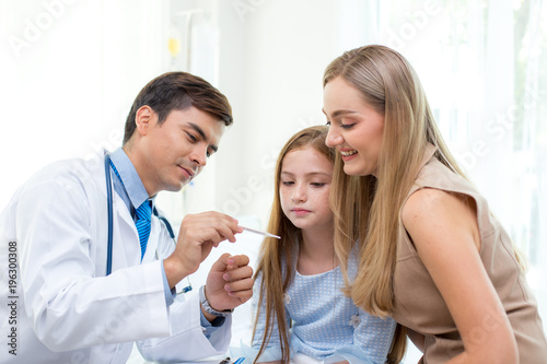 Male doctor examining girl in clinic. People with health care and medical concept