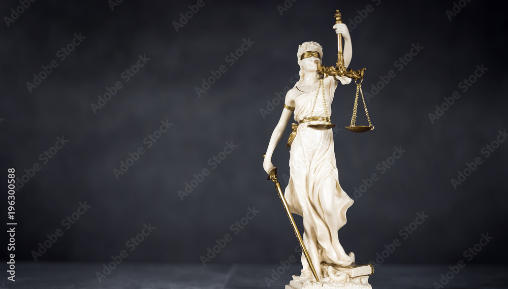 Obraz premium Law and Justice concept. Mallet of the judge, books, scales of justice. Gray stone background, reflections on the floor, place for typography. Courtroom theme.