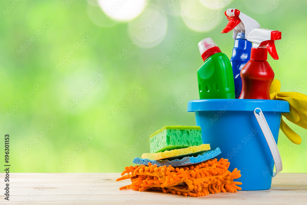 Cleaning concept - cleaning supplies on wood background Cleaning concept - cleaning supplies on wood background