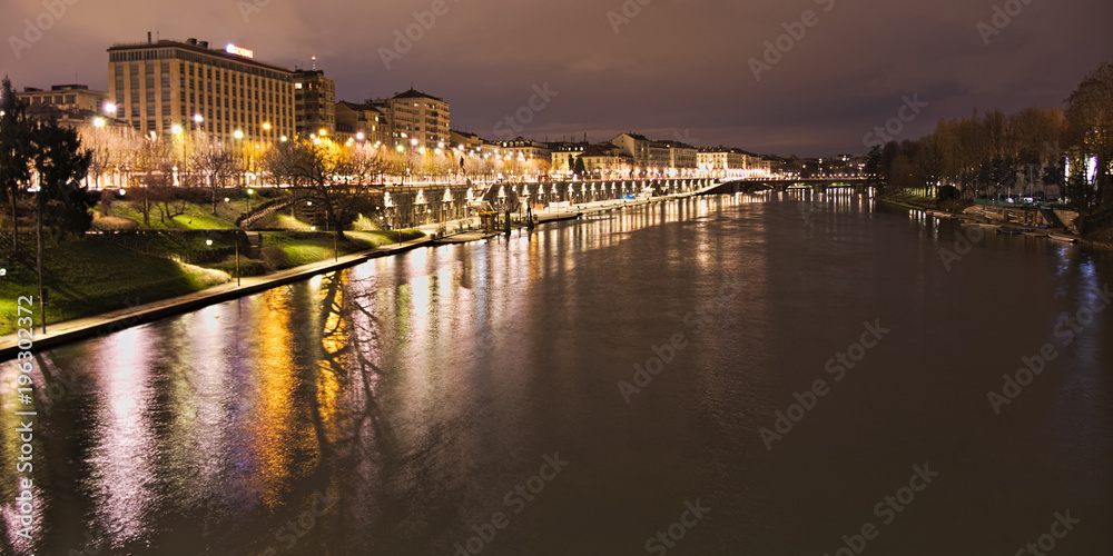 Po river flowing in Torino city, Italy, Murazzi docks, night view