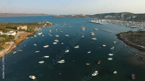 Picturesque mediterranean seascape of Aegean sea bay with yachts, sailing, motor and fishing boats spread all over water. Olympic marina on the background. Lavrio town, Attica, Greece. Aerial. photo