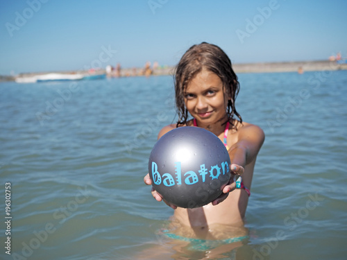 Little girl and littel boy playing in water photo